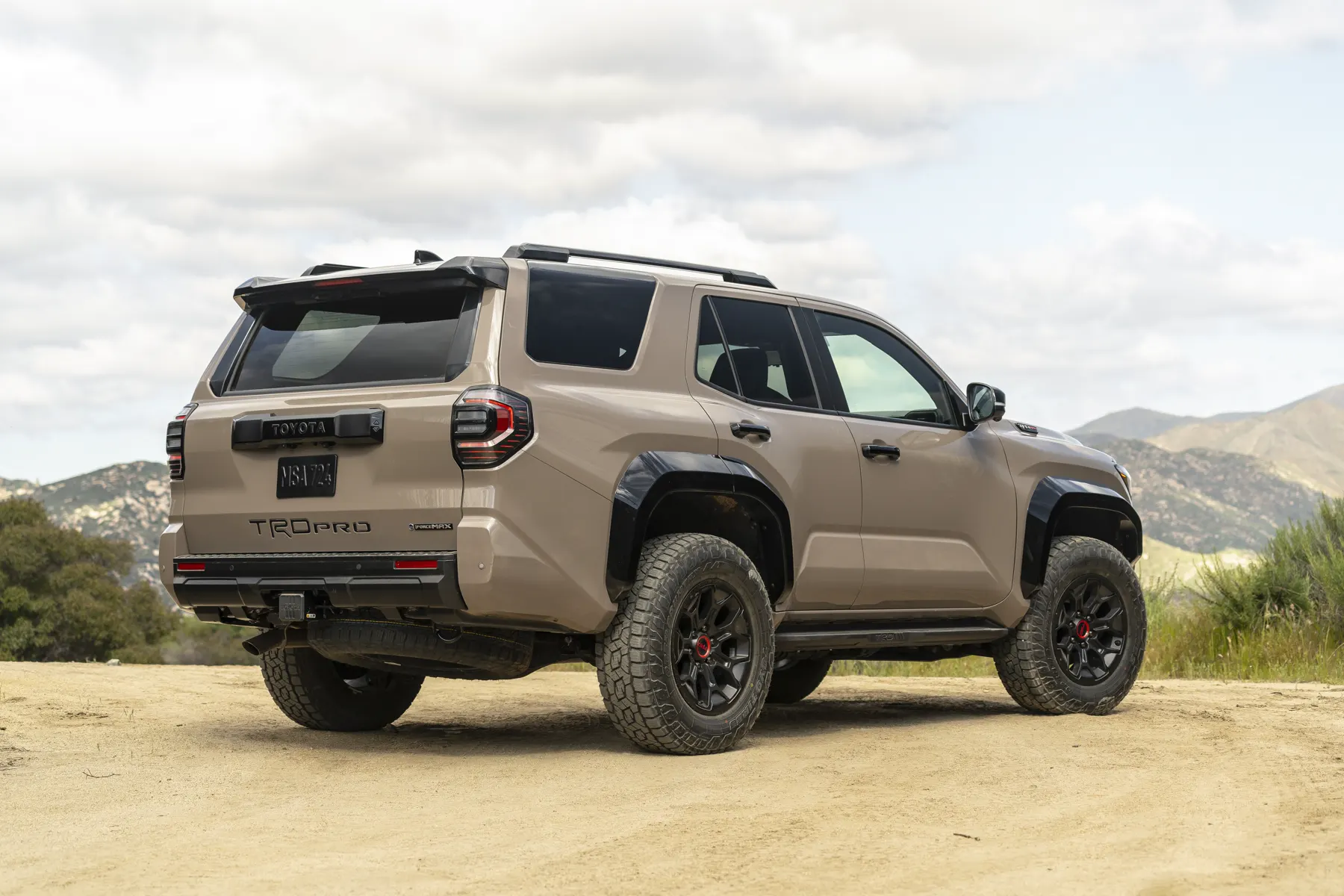 2025 Toyota 4Runner TRD Pro in Mudbath, rear three-quarter on a dirt clearing
