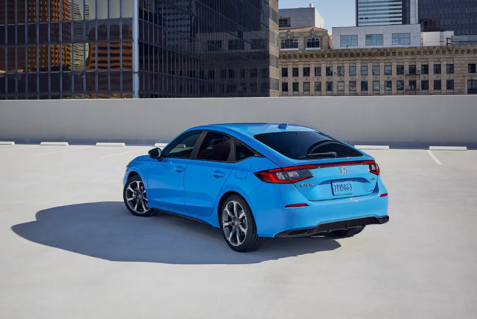 Blue 2025 Honda Civic Hatchback Sport Touring Hybrid, rear three-quarter on a rooftop deck