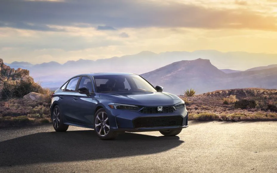 2025 Honda Civic Sedan Sport Touring Hybrid, front three-quarter on a desert road