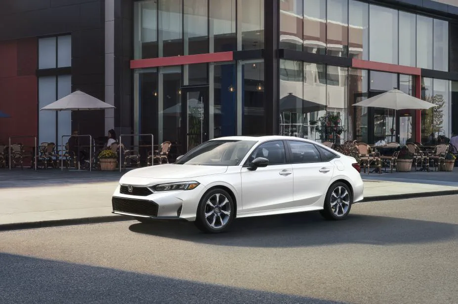 White 2025 Honda Civic Sedan Sport Touring Hybrid parked on a city street