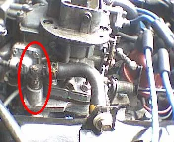PCV valve plugged into a valve-cover grommet with a hose nipple