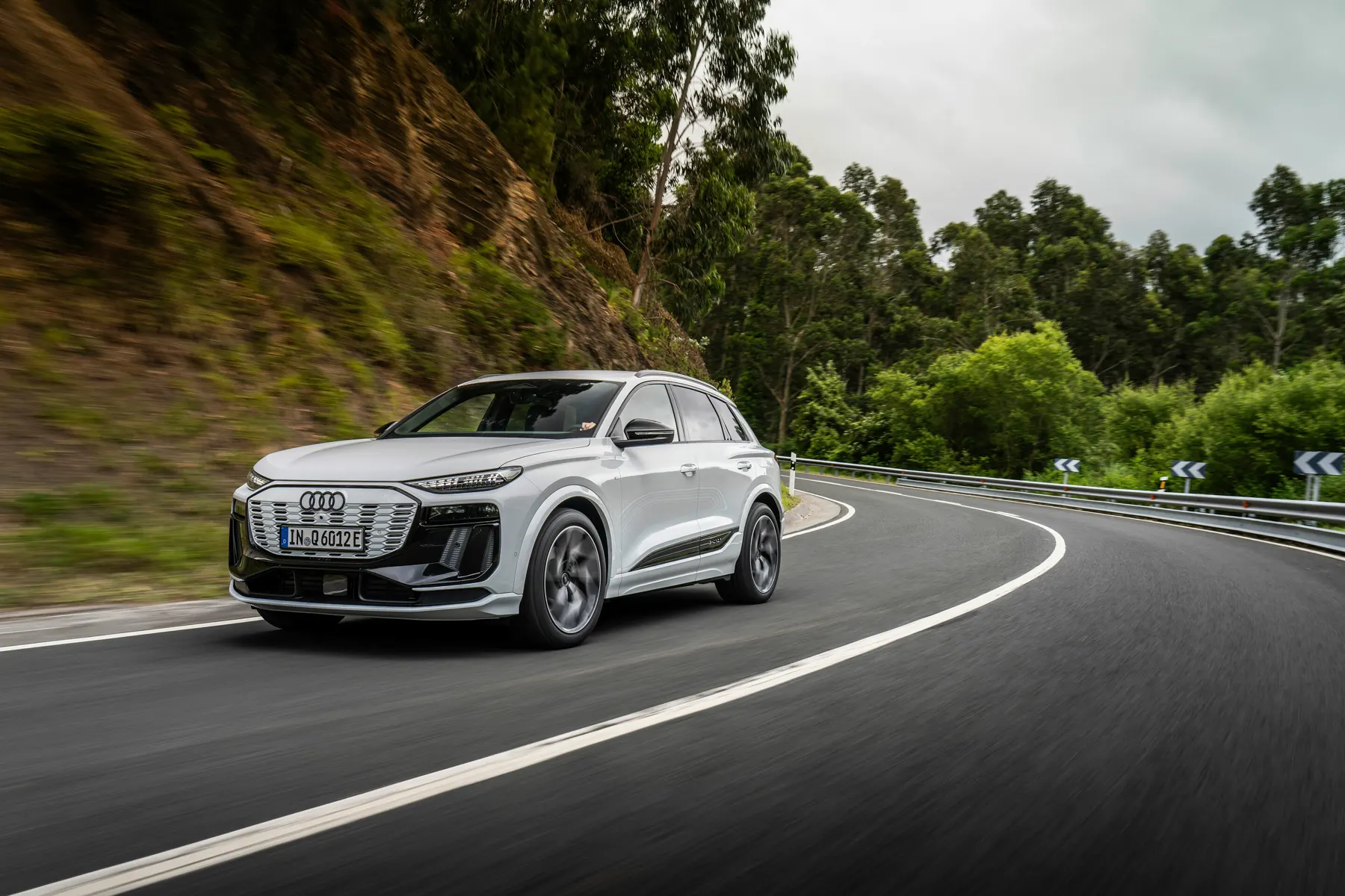 White 2026 Audi Q6 e-tron, front three-quarter showing the closed textured grille