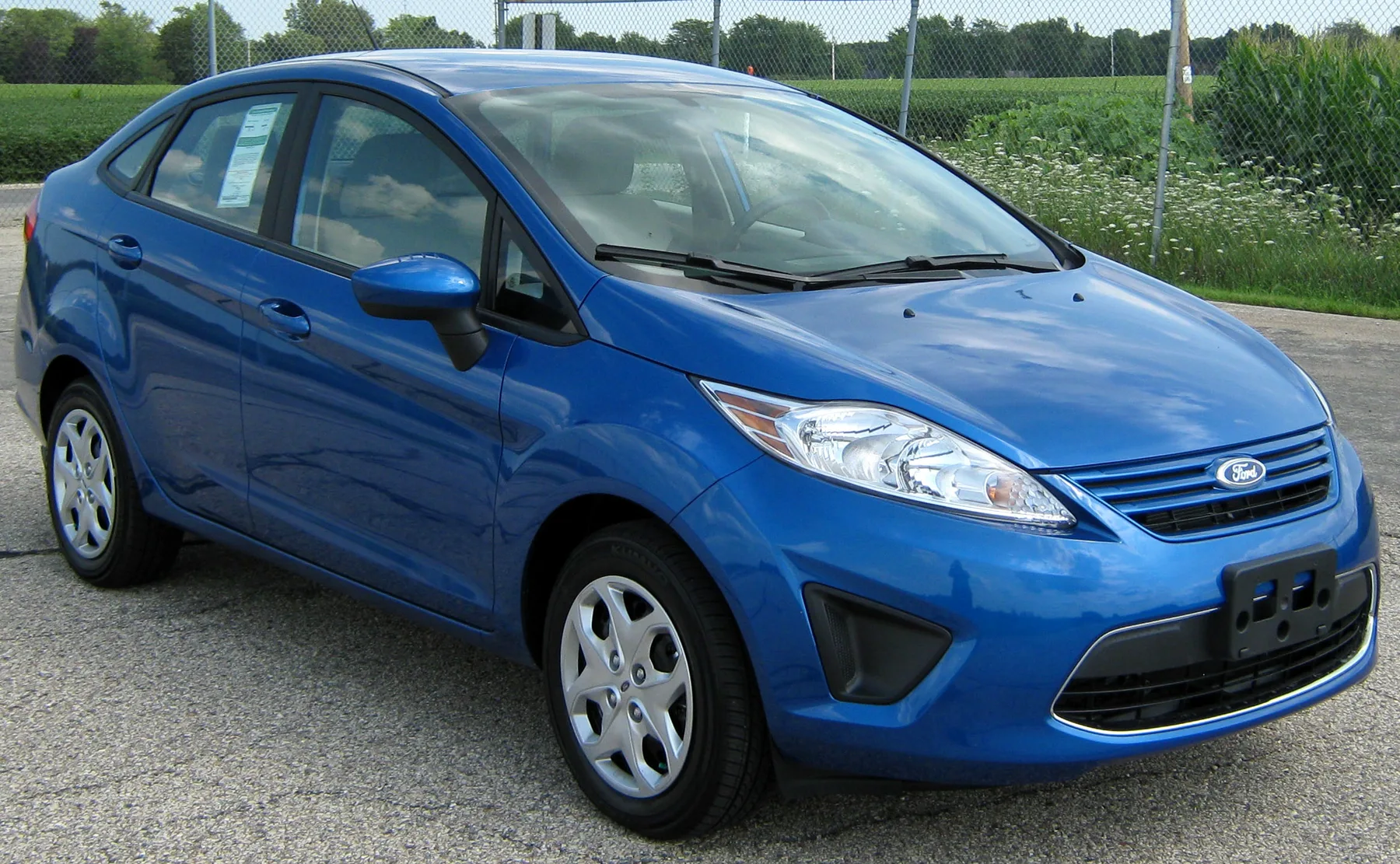 Blue Ford Fiesta sedan in an official NHTSA test photograph