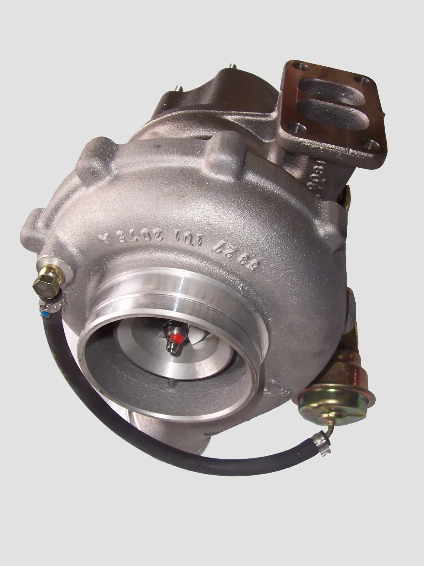 Gold wastegate actuator can, black hose, and rod on a turbo compressor housing